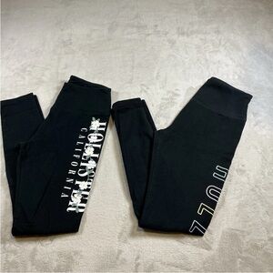 A set of two Hollister Black Leggings with White Daisy & Logo Side Prints